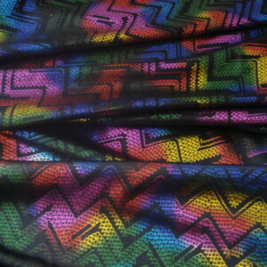Tejido en licra f/negro estampado psicodélico