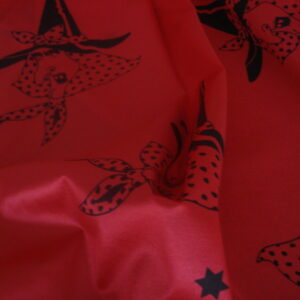 Tejido en rasete f/rojo dibujo caras bruja