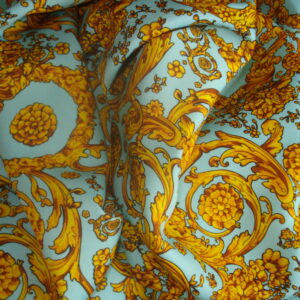 Tejido en crepe fondo azul, estampado dorado