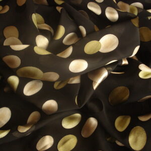 Tejido en gasa f/negro, estampado círculos ovalados verdes, beige