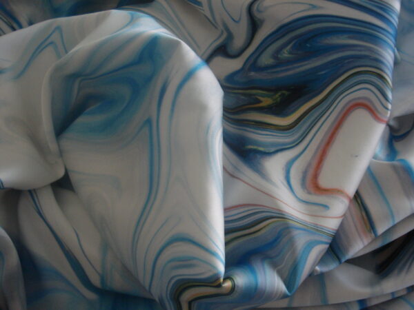 Tejido en crepe satinado colores azules marmolado, ancho 1.50mts.