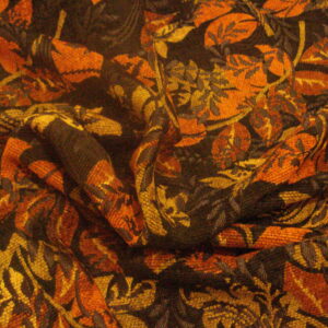 Tejido tipo "tapicería" c/fondo negro hojas marrones-verdes, ancho 1.44mts.